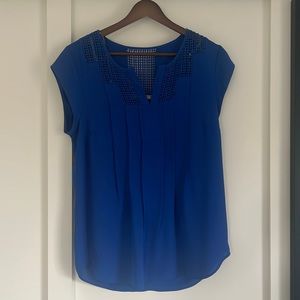 Short sleeved blouse in royal blue with geometric cut outs in front and back